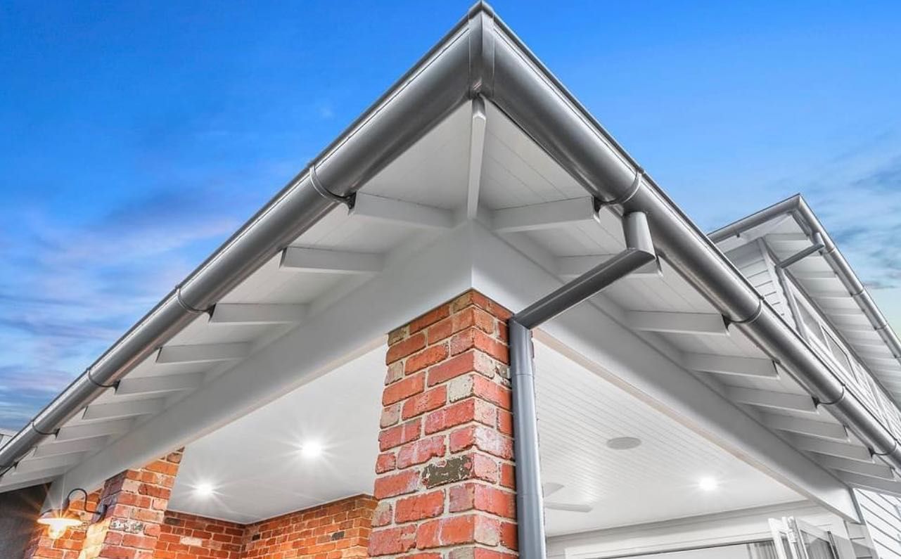 The Roof of a House With a Brick Chimney and Gutters — Goulburn Roofing In Canberra, NSW