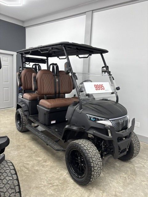 White six-seat golf cart with tan seats and black roof, shown on a plain white background