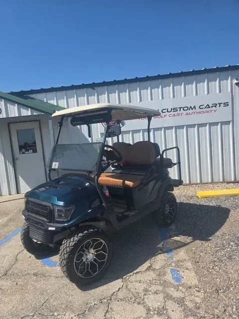 Blue and tan custom golf cart parked in front of a building with 