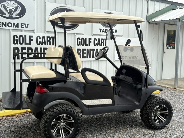Maroon golf cart parked on gravel outside a golf cart rental building