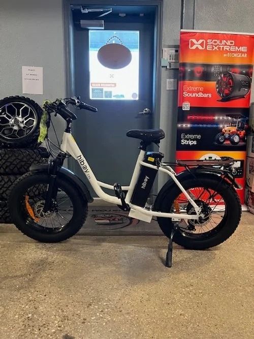 White electric bicycle with fat tires in a shop.