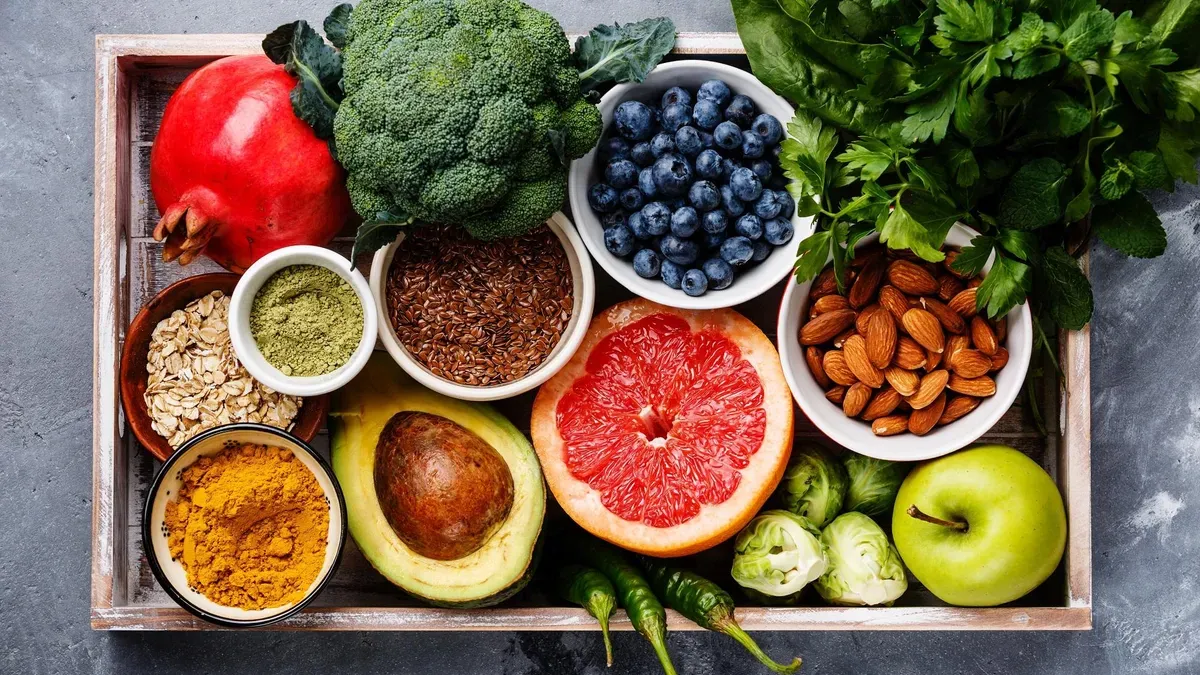 A wooden box filled with a variety of fruits and vegetables.