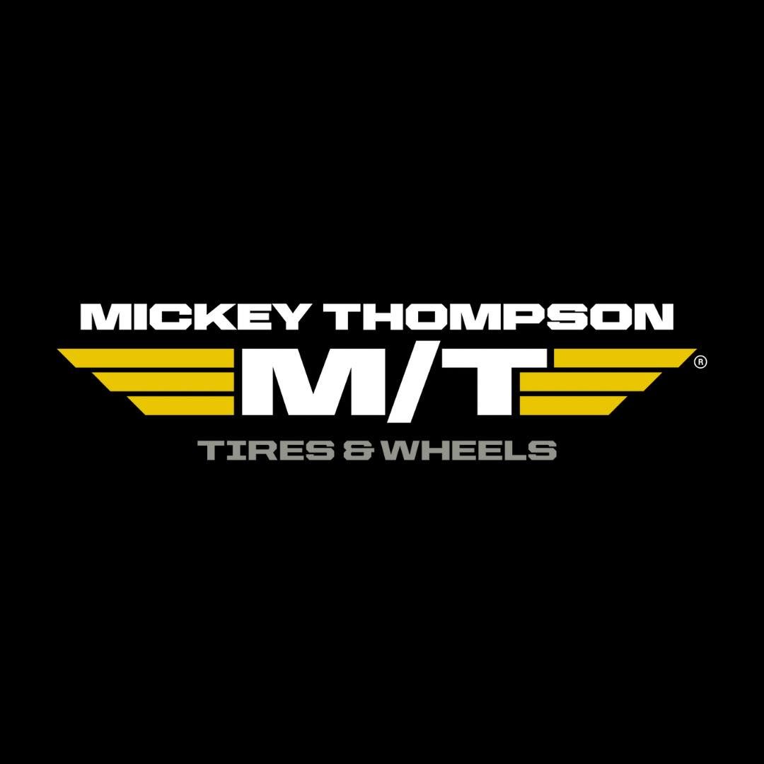 Mickey Thompson Tires & Wheels logo: white text and a gold M/T emblem on a black background.