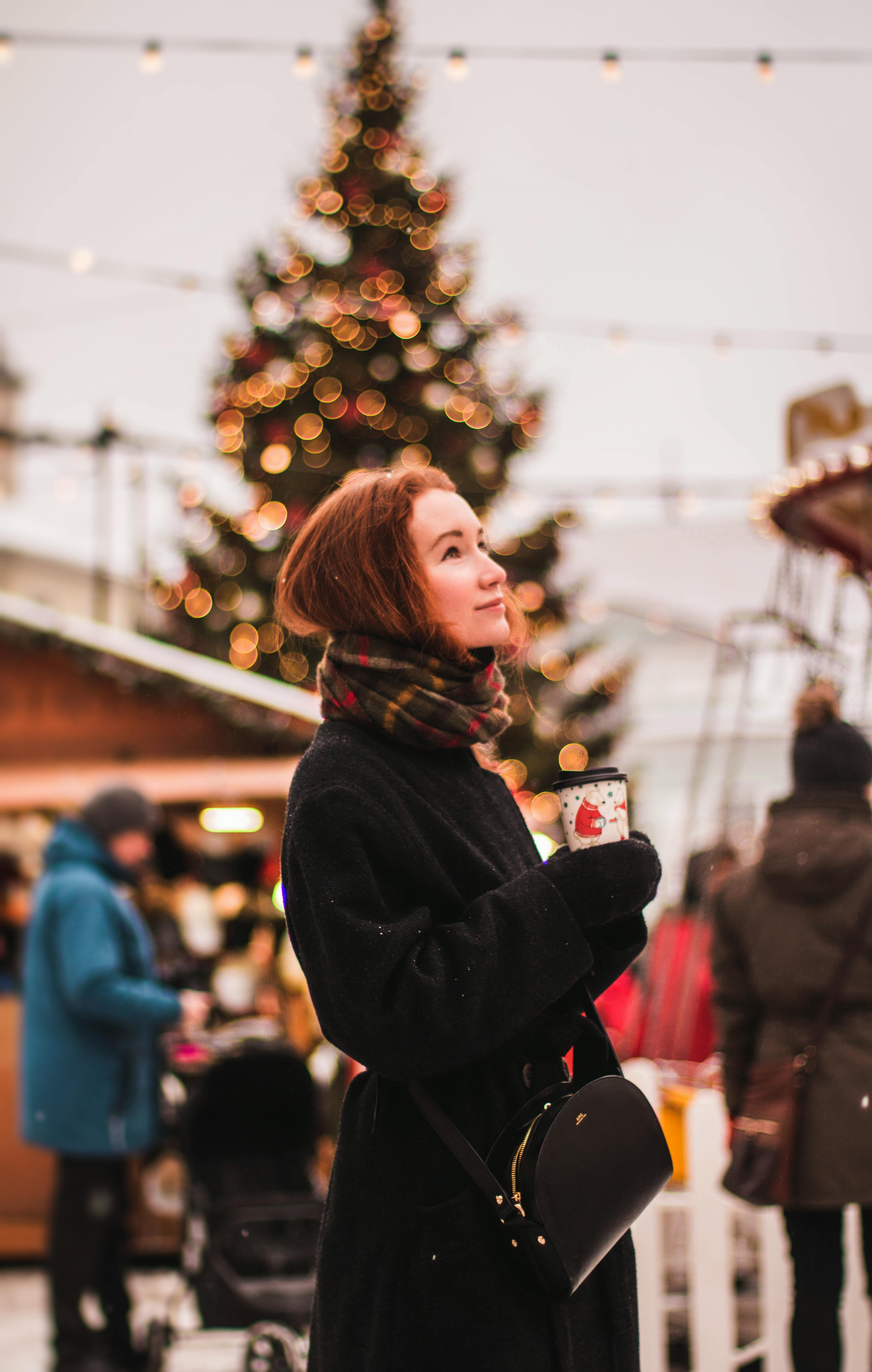 Lady standing in front of Christmas tree