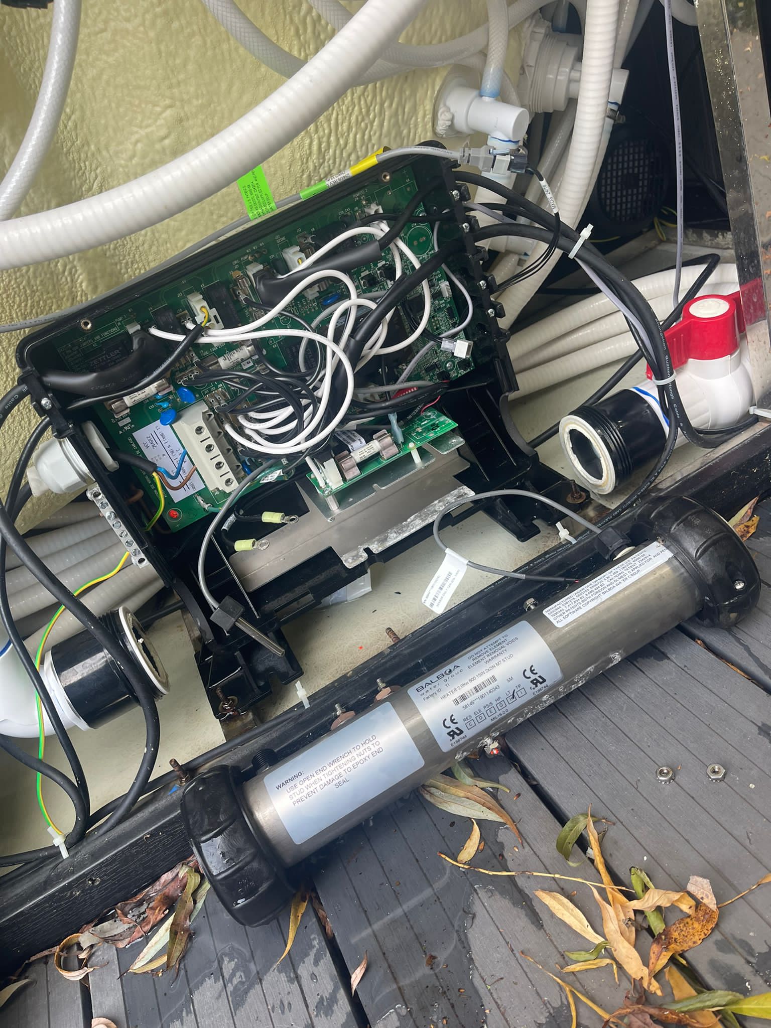The inside of a hot tub with a lot of wires coming out of it.