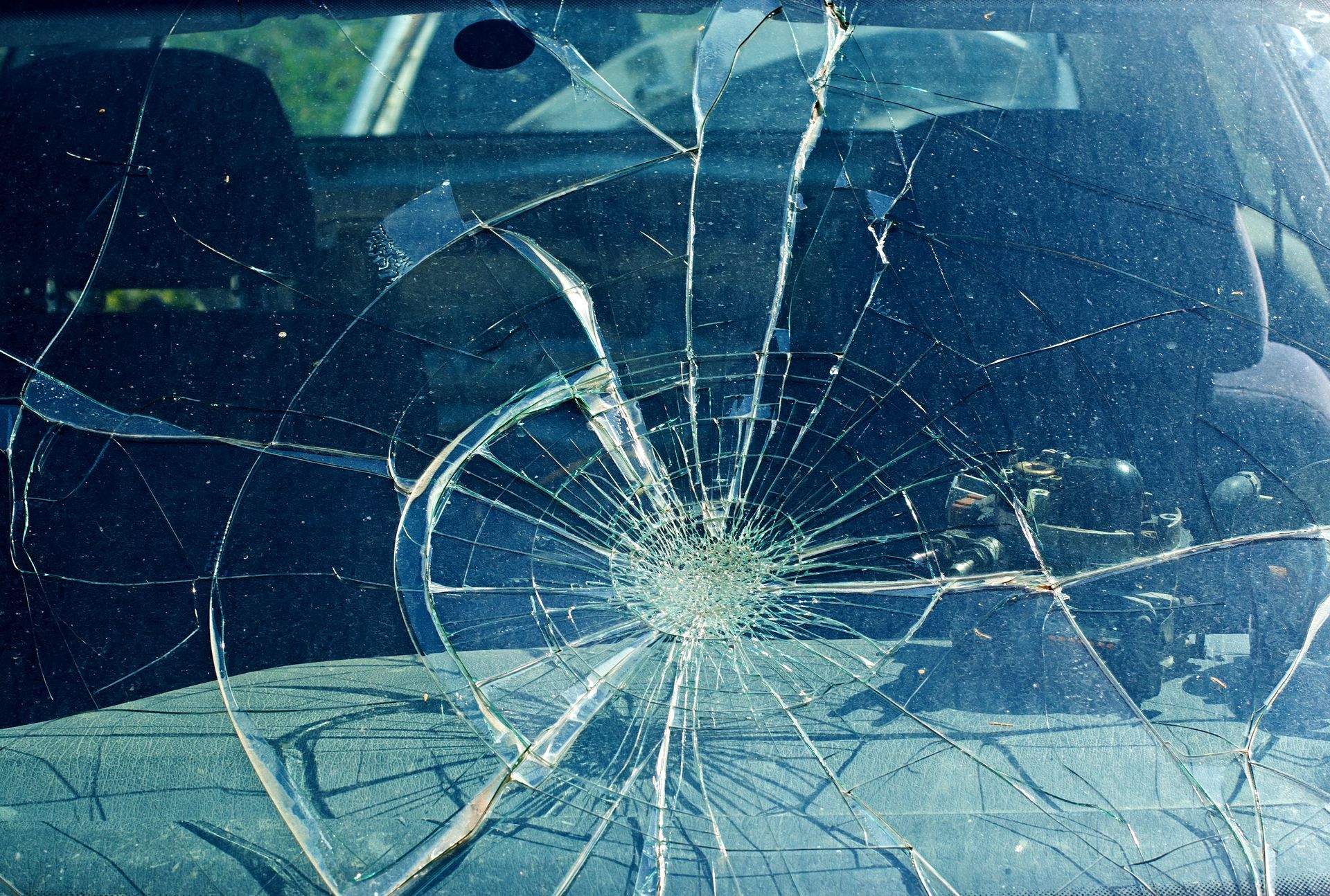 A close up of a broken windshield of a car