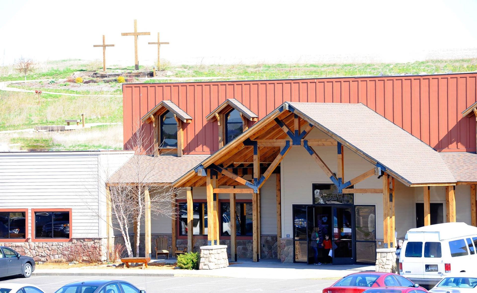 A building with three crosses on top of a hill