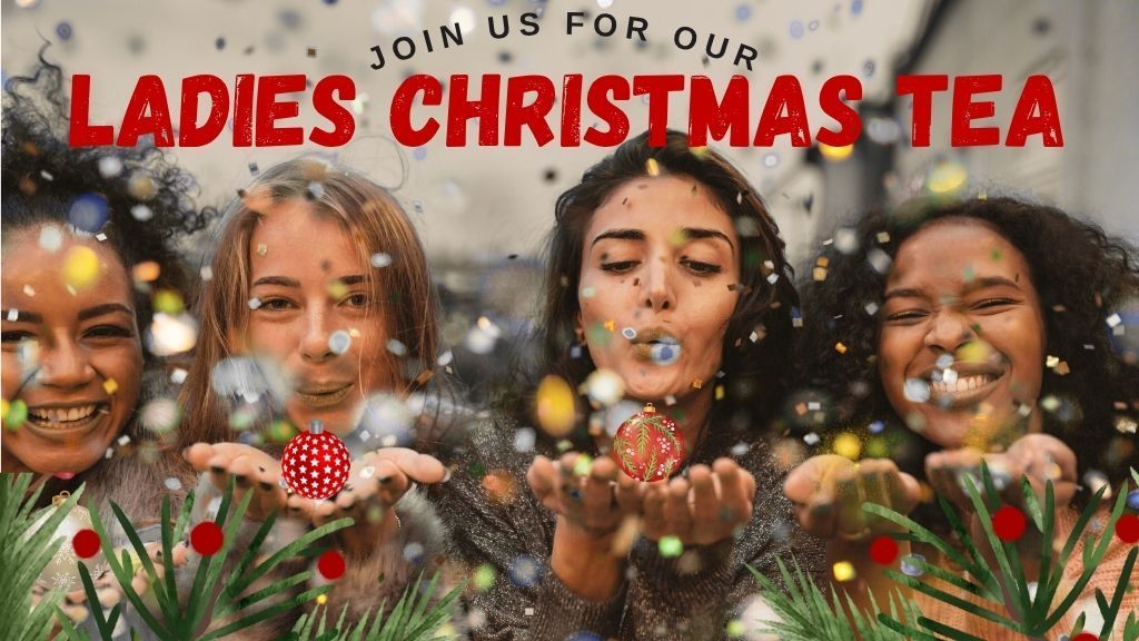 Four women blowing confetti at a Ladies Christmas Tea.