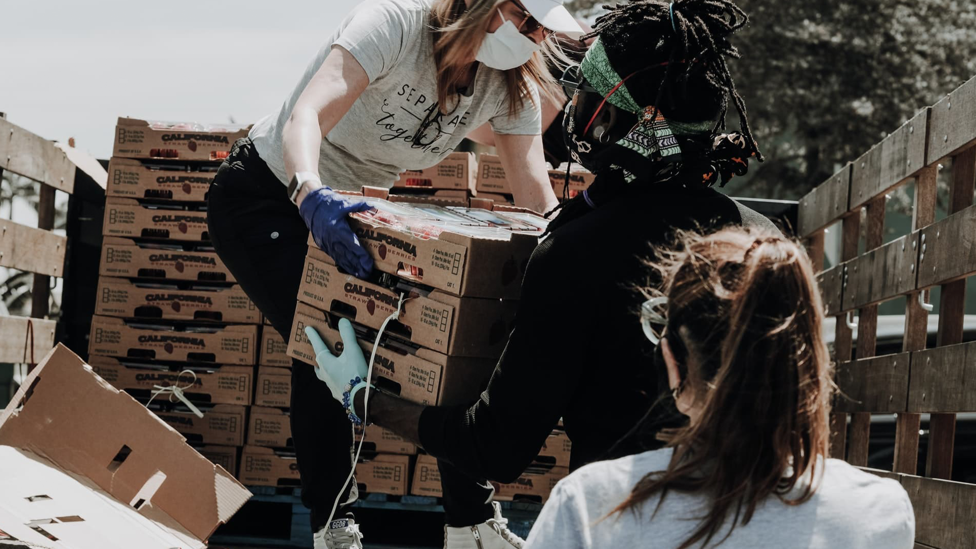 A group of people are loading boxes into a truck.