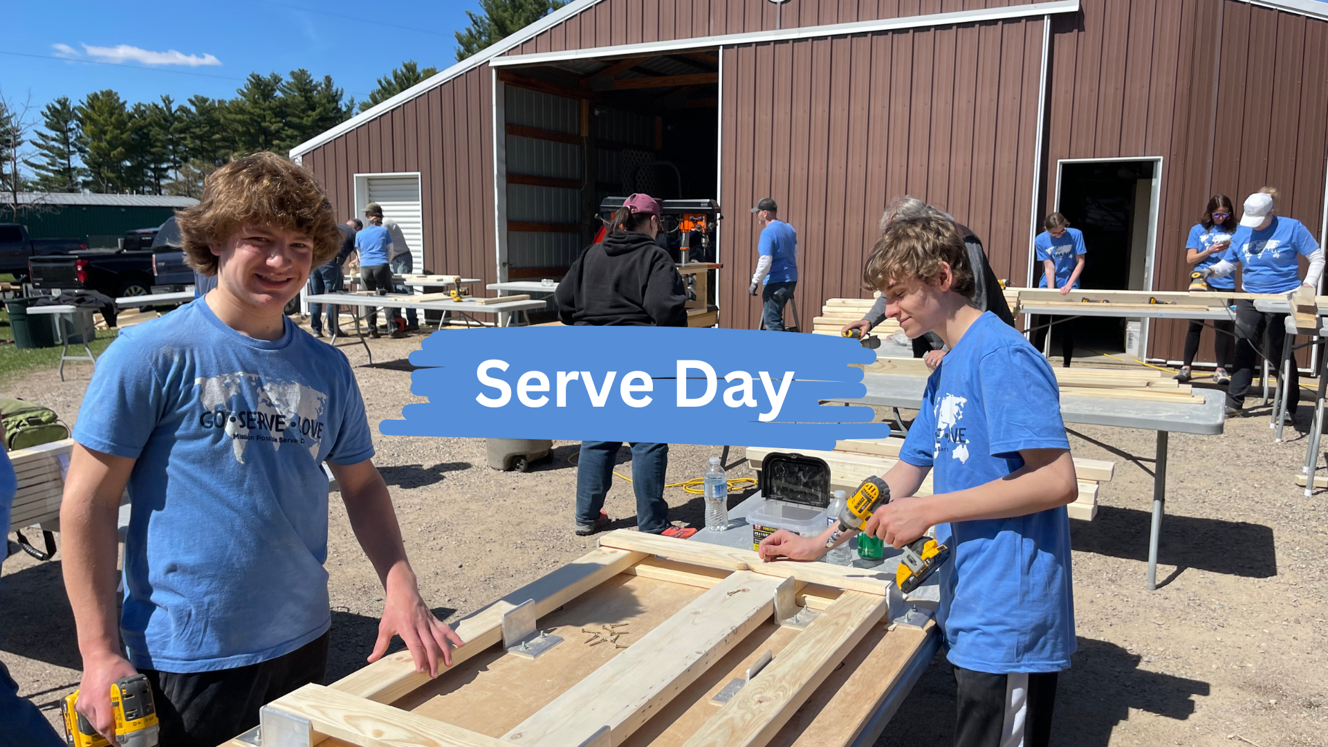 A group of young men are working on a wooden pallet.