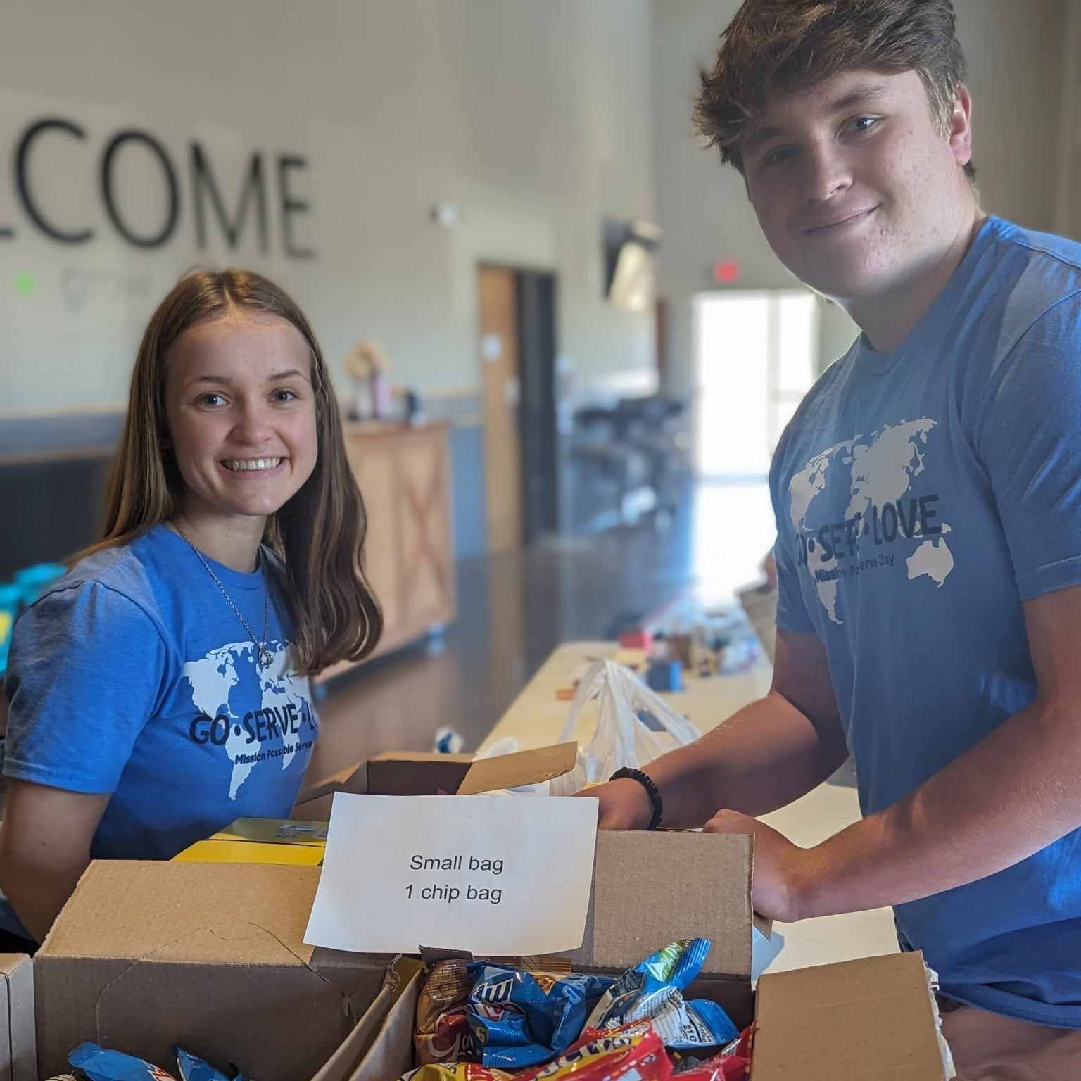 A man and a woman volunteering.