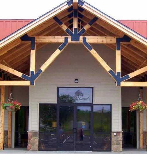 The front of Cedarbrook Church with a red roof and wooden beams