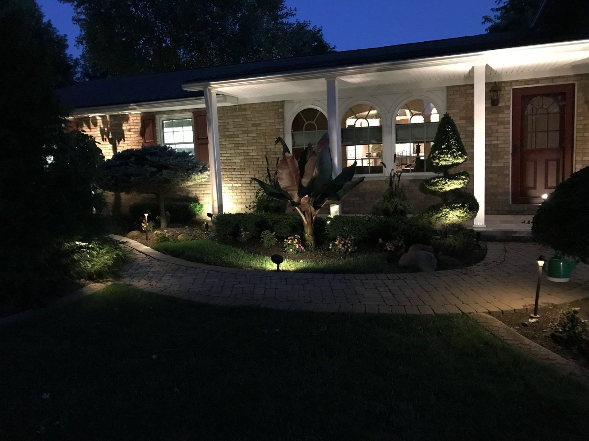 The front of a house is lit up at night.