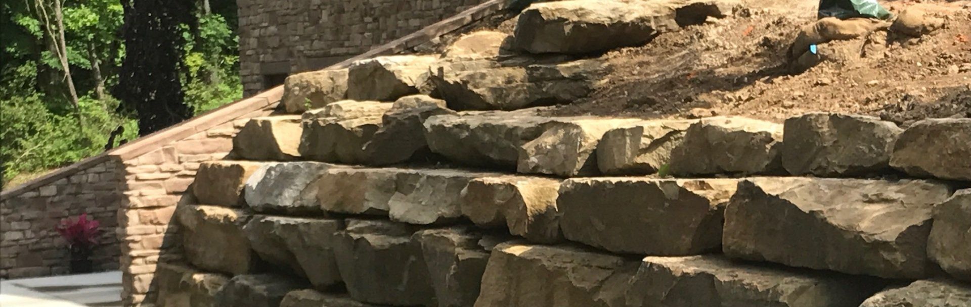 A pile of rocks sitting next to a set of stairs.