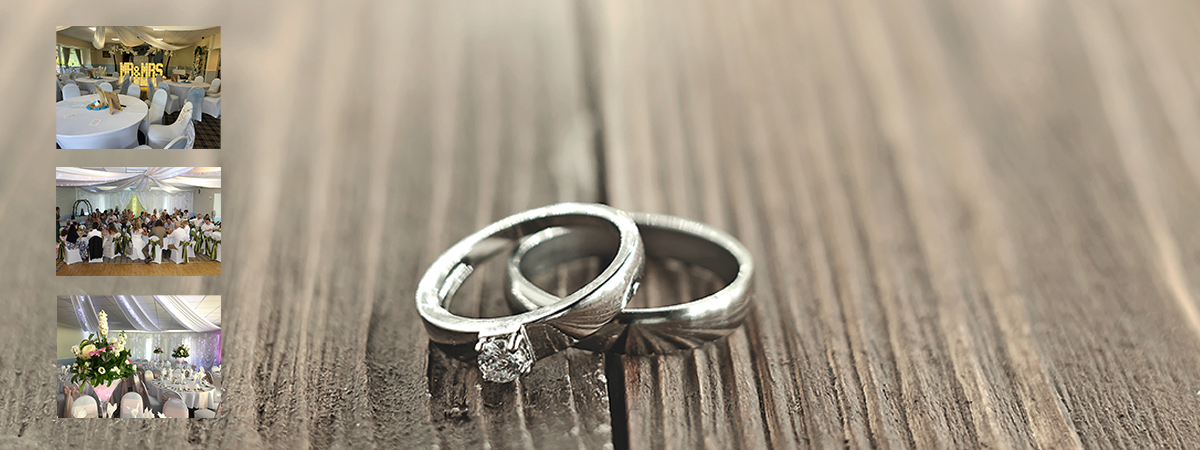 A pair of wedding rings are sitting on a wooden table.