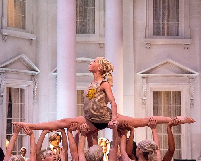 A group of cheerleaders are doing splits in front of a white house.  | Springfield, IL | Dance Creations Dance Studio