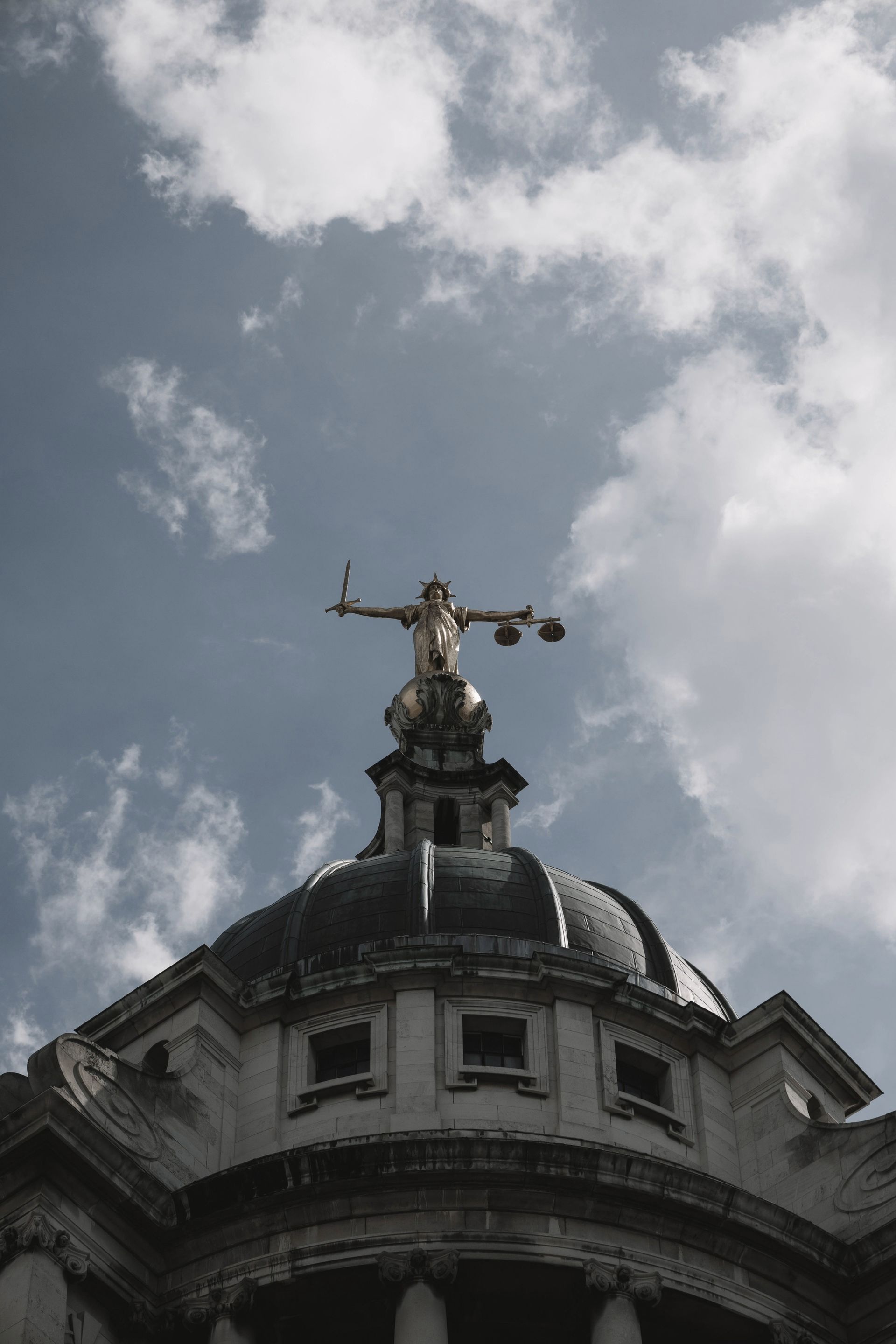 A statue of justice is on top of a building