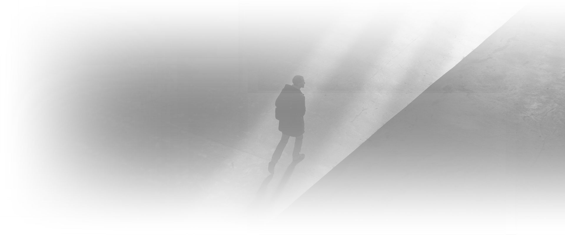 A silhouette of a person standing in the fog.