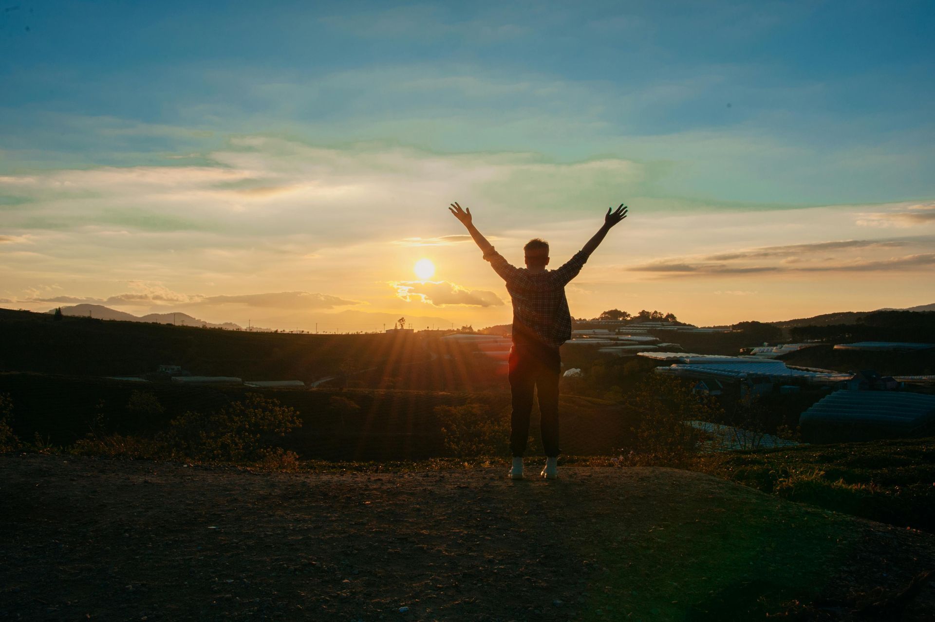 Man with arms in air celebrating freedom.