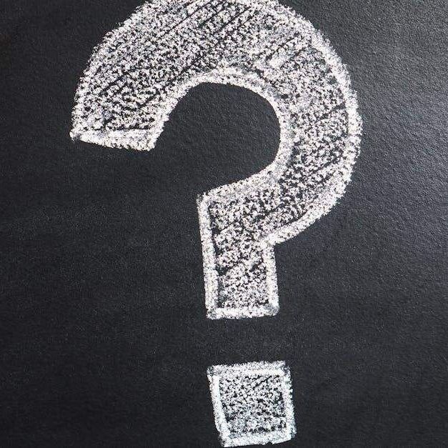 A question mark drawn in white chalk on a blackboard