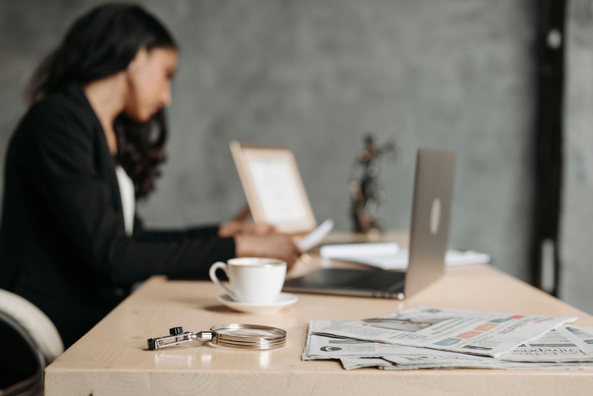 Lady sat at a desk looking at a computer 