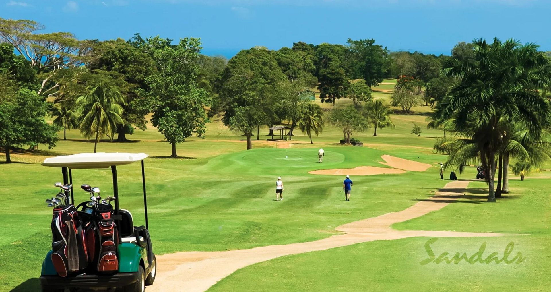 Leaving the golf cart behind, golfers walk down the fairway to the green.