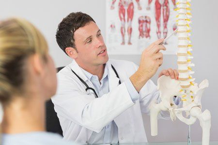 Doctor showing a patient something on skeleton mode - Orthopedic in Sewell NJ