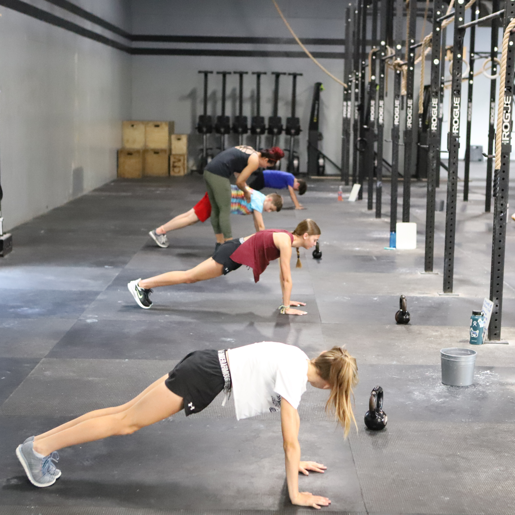 A group of people are doing push ups at CrossFit Vertex gym in Olyphant, PA