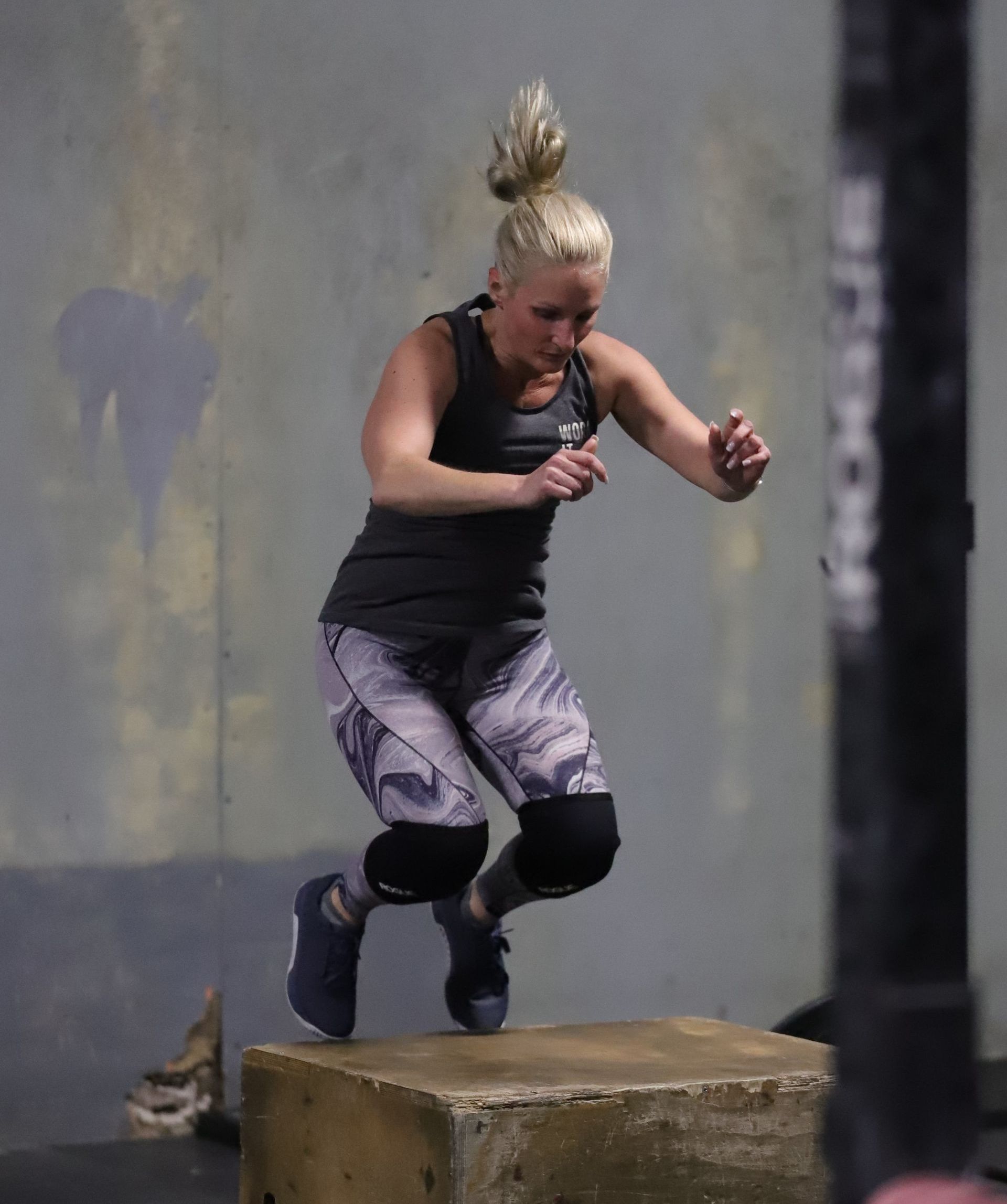 A woman jumping on a box.