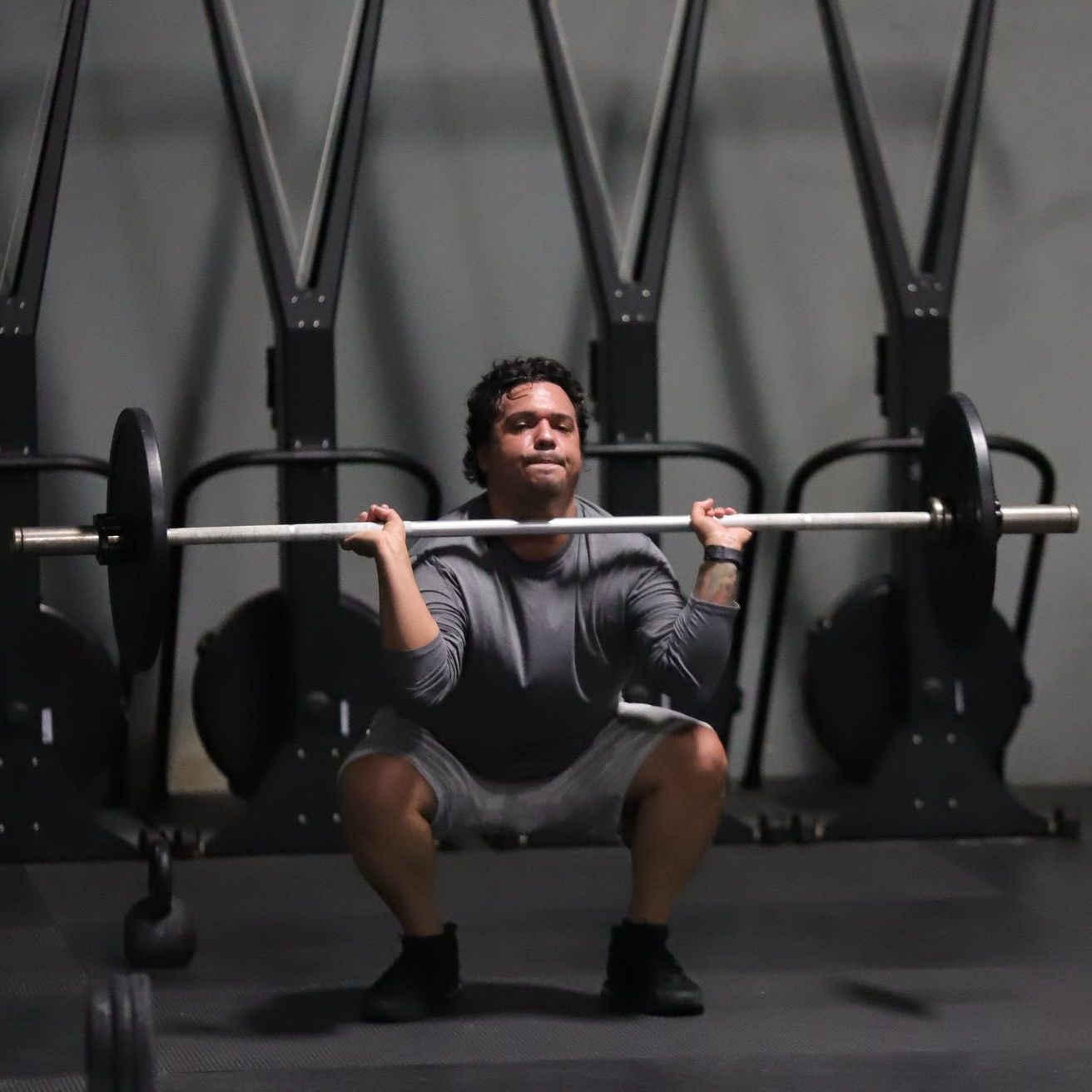 A man lifts a barbell.