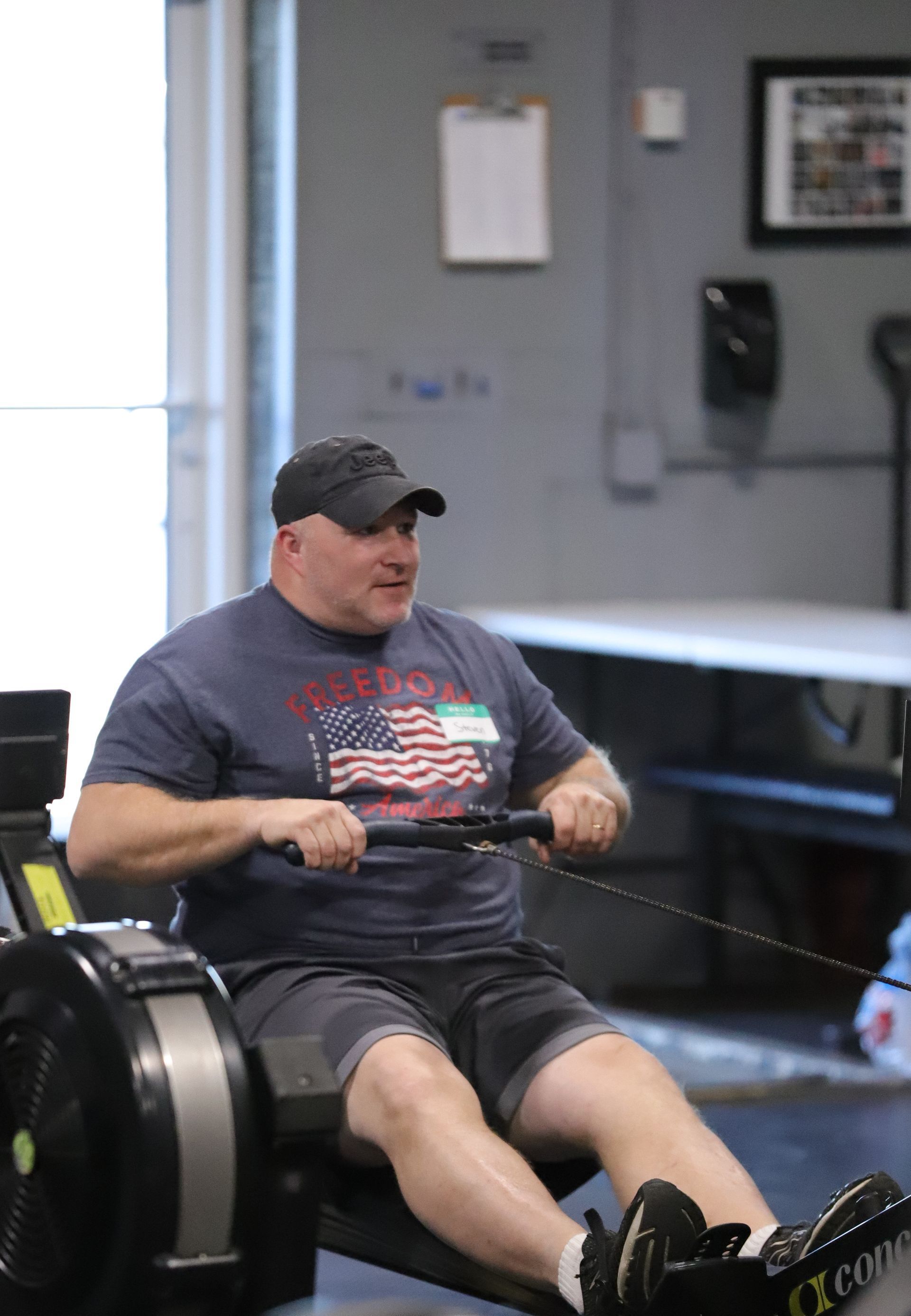 A man exercises on a rowing machine.