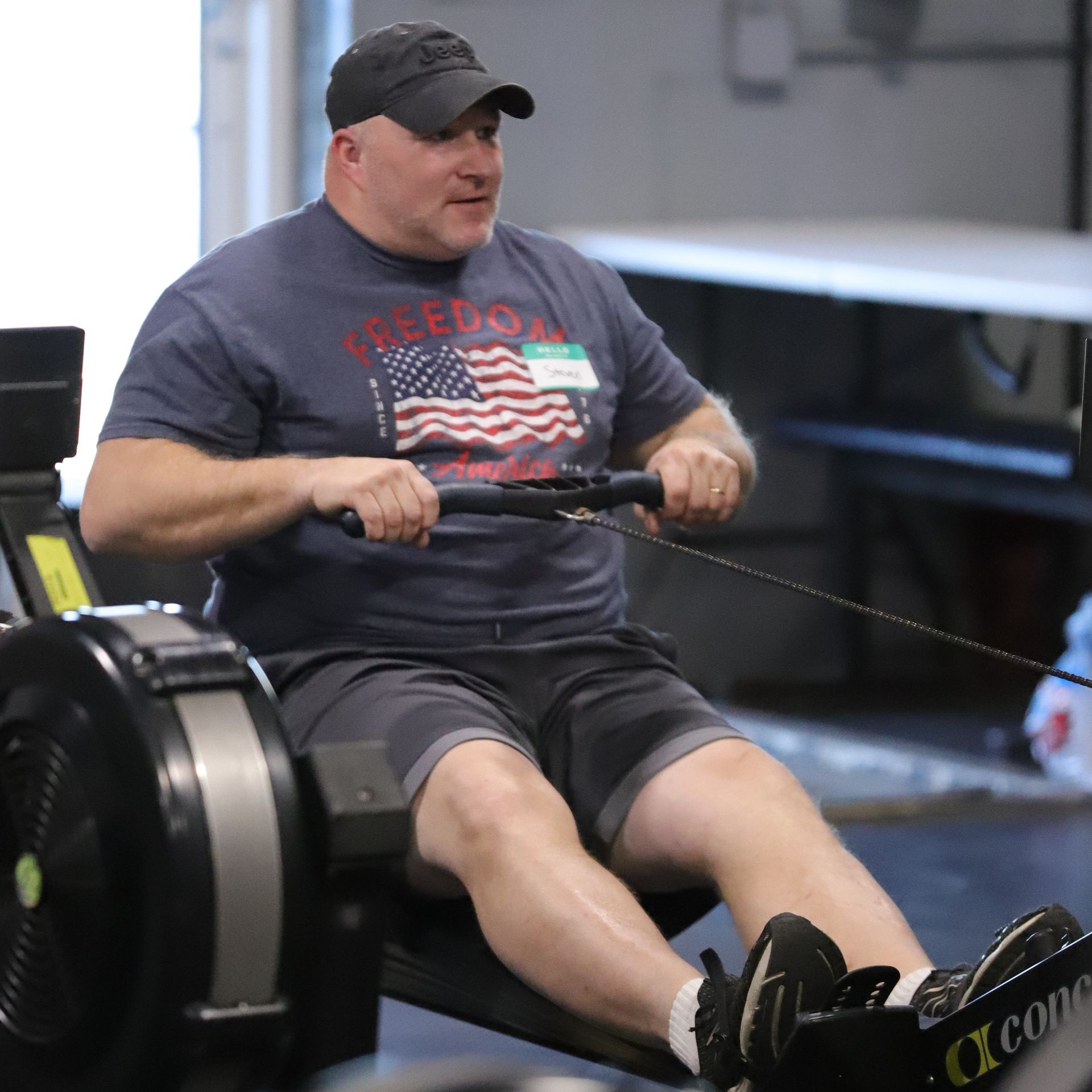 A man exercises on a rowing machine.