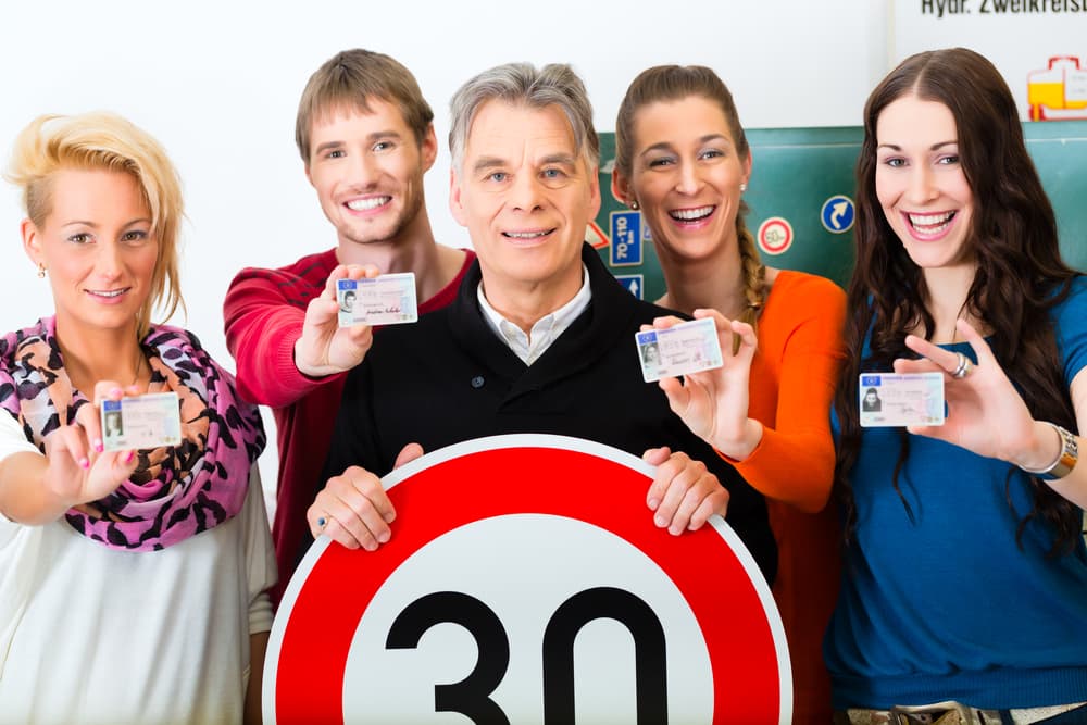 A Group of People Holding Up Their Licenses and a Sign That Says 30 — NT Driving Academy in Woolner, NT