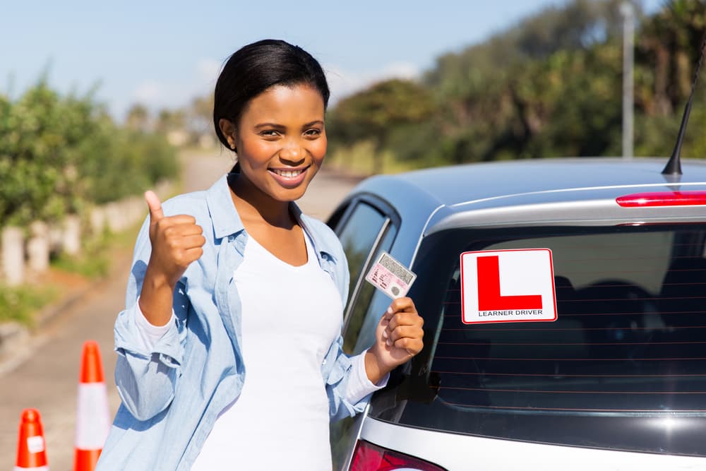 Smiling Woman Holding Her License - Driving Academy In Woolner, NT
