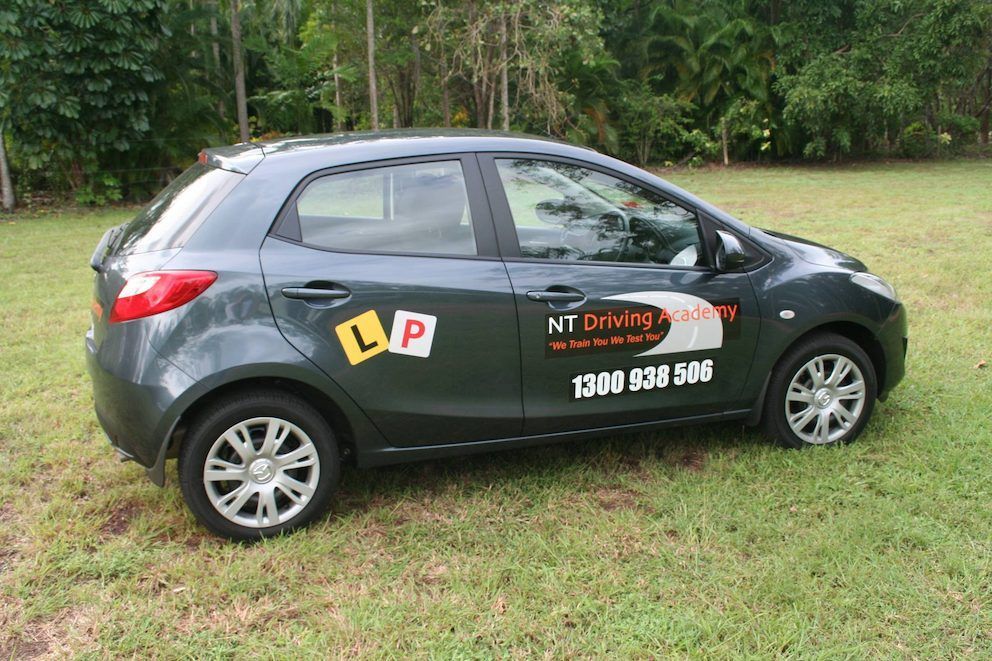 A Car With a License Plate That Says Lap is Parked in a Grassy Field — NT Driving Academy in Woolner, NT
