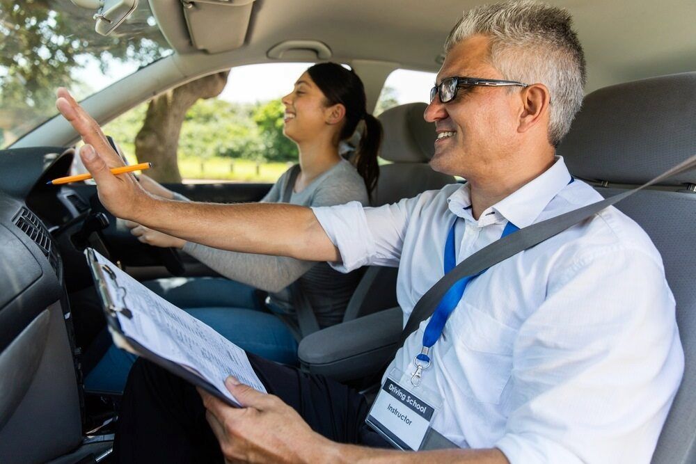 A Man is Teaching a Woman How to Drive a Car — NT Driving Academy in Darwin, NT
