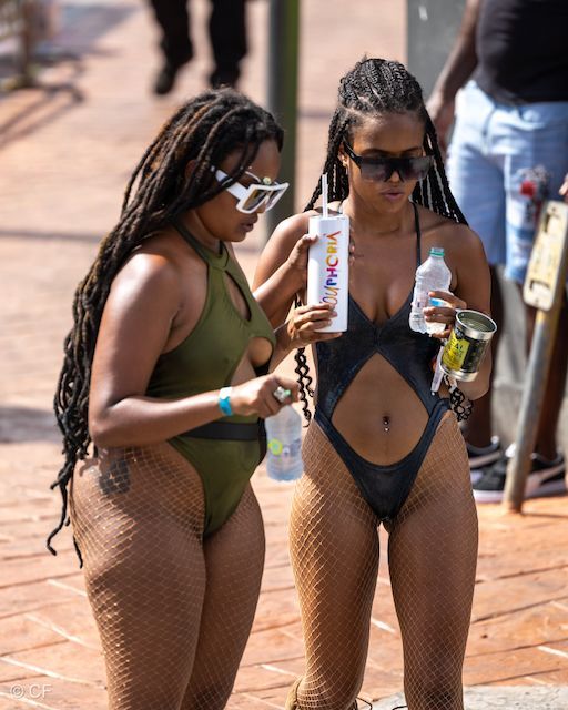 Two women in swimsuits are standing next to each other
