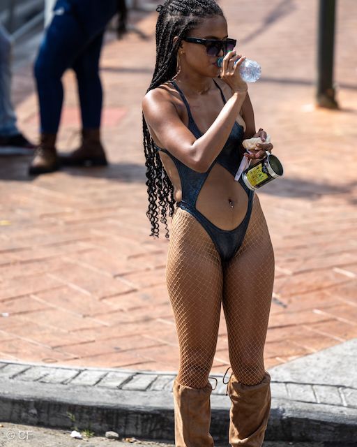A woman in a bathing suit drinking from a bottle