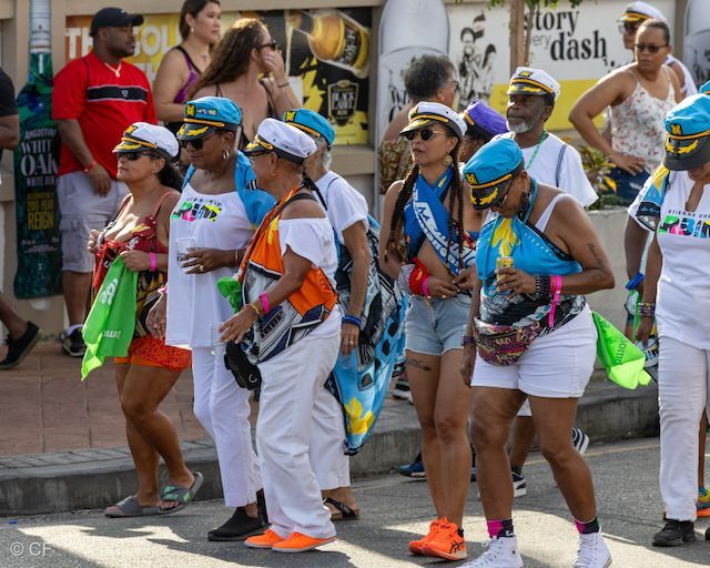 A group of people are walking down a street in front of a sign that says story dash