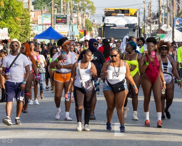 A group of people are walking down a street.