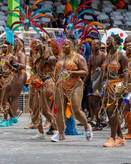 A group of people in colorful costumes are dancing in a parade.