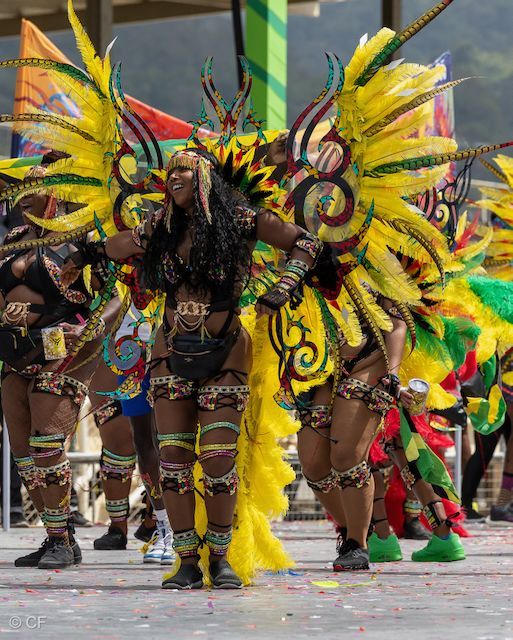 A group of people in colorful costumes are dancing in a parade.