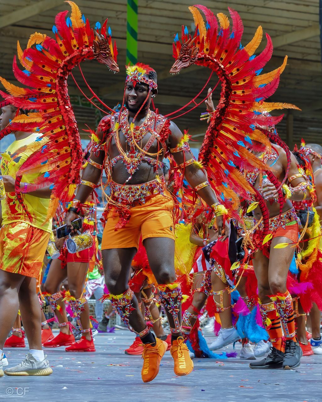 A group of people in colorful costumes are dancing in a parade.