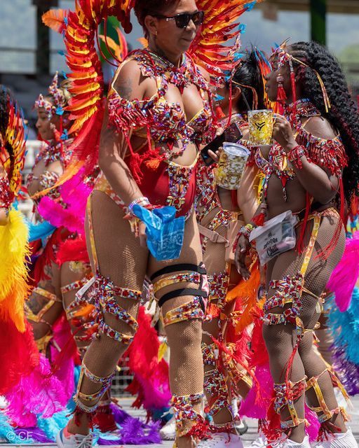A group of people in colorful costumes are dancing in a parade.