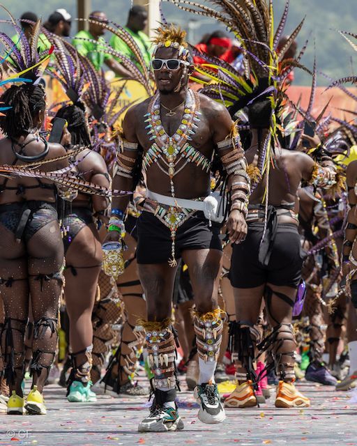A group of people are walking down a street in a parade.