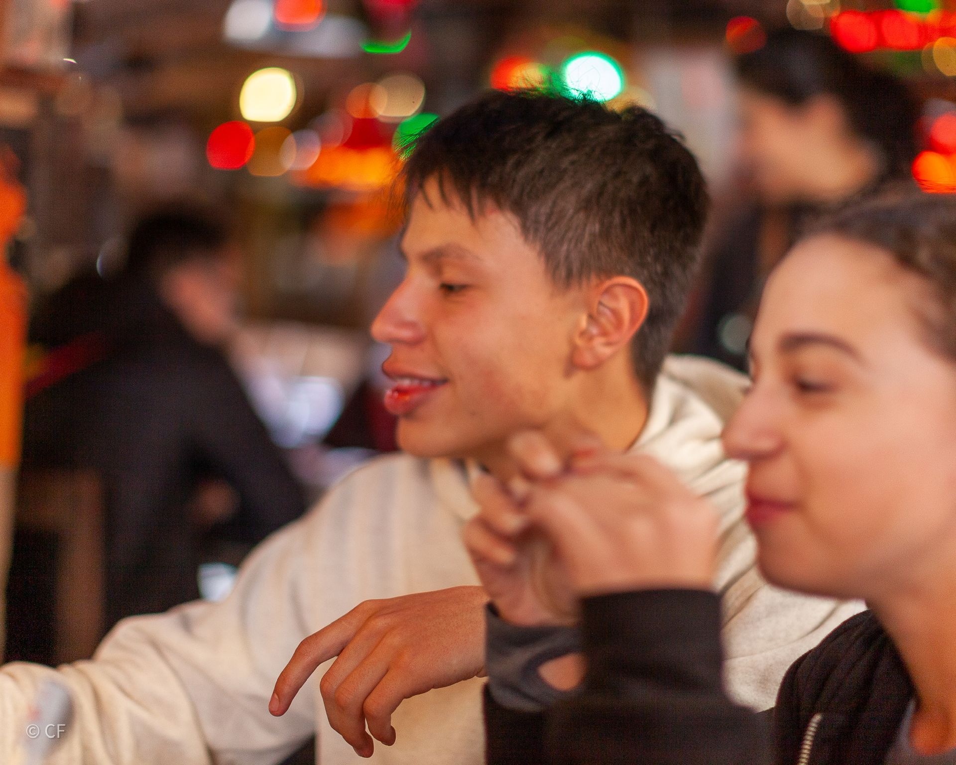A man and a woman are sitting at a table in a restaurant