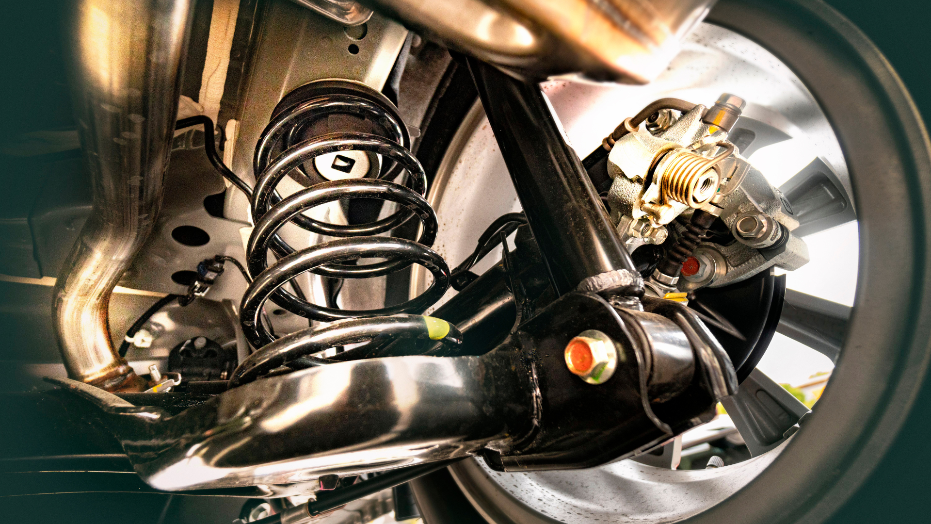 A close up of the underside of a car with a shock absorber.