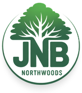 A logo for jnb northwoods with a tree in the center