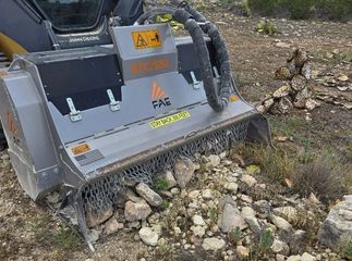 A machine with the word fas on it is cutting rocks