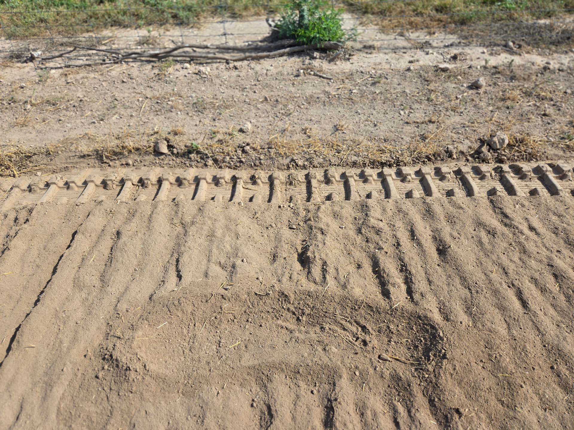 A close up of a tire track in the dirt